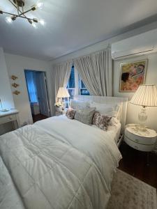 a bedroom with a large white bed and two lamps at J and M on Capital Boutique Guesthouse in Frankfort