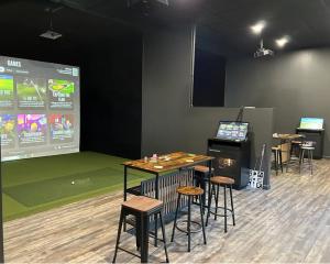 a room with tables and stools and a projection screen at Almost Heaven - Grill, 2 King Beds, Wifi, Deck, Pool Access, Hiking, Wood Stove, Family Friendly in Berkeley Springs