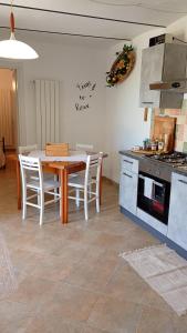 a kitchen with a table and chairs and a stove at Da Lucia in Francavilla al Mare +37 photos