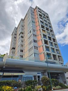 a tall apartment building in front of a building at Grayscale Studio in Caniço