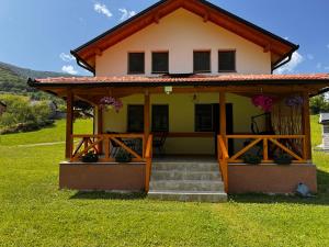 a small yellow house with a red roof at River Resort Vinac Jajce in Jajce +45 photos