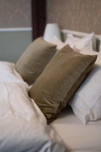 a pile of pillows sitting on top of a bed at Hótel Blönduós in Blönduós