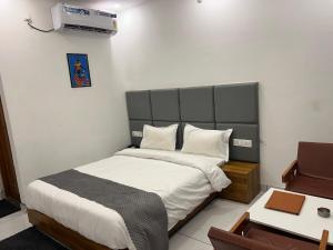 a small bedroom with a bed and a desk at The Shalam Resort श्रीकृष्ण शरणं मम in Lansdowne +153 photos