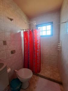a bathroom with a shower with a toilet and a window at Casa ampla Churrasqueira Natureza Maricá RJ in Maricá