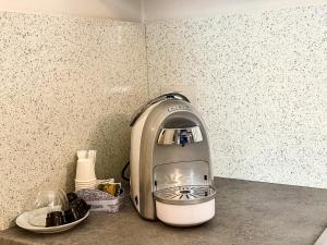a coffee maker sitting on a counter in a kitchen at Finya Apartments - Affitti Brevi Italia in Gravina in Puglia