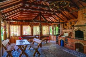 a living room with a stone fireplace and a stone table at Pensiunea Colt De Rai in Sîmbăta de Sus