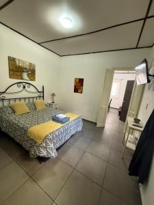 a bedroom with a bed and a room with a table at Departamento Mis Nonos 4 in Mendoza