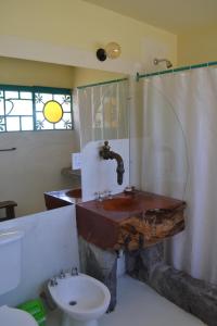 a bathroom with a sink and a toilet at El Churqui in Cafayate