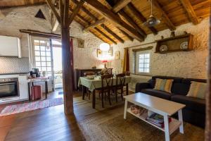 a living room with a couch and a table at Gîte des granges in Fargues