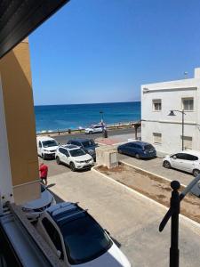 a parking lot with cars parked next to the ocean at Apartamentos La Almadraba 1-5 in El Pozo del Cabo +12 photos