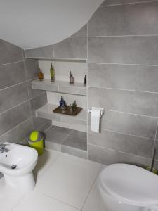 a bathroom with a white toilet and a sink at Casa di a Murza vue citadelle Rdc in Calvi +11 photos