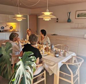 a group of people sitting at a table eating at TheGilgahouse Gardenroom in Nakskov
