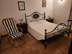 a bedroom with a bed and a rocking chair at Valtrebbia Relax in Ponte