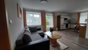 a living room with a couch and a table at Haus Monika in Obsteig