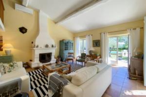 a living room with a couch and a fireplace at Villa with 5 Bedrooms and Private Pool in Grimaud