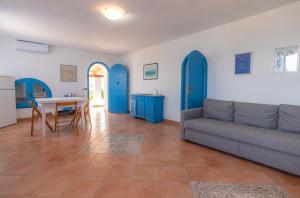 a living room with a couch and a table at Villa Angela - Ginevra in LMP +16 photos