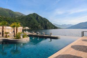 a swimming pool with a view of a lake at Grand Hotel Victoria concept & spa, by R Collection Hotels in Menaggio +80 photos