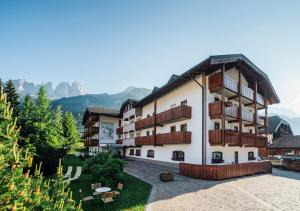 a large building with balconies on the side of it at Garni Aritz in Campitello di Fassa