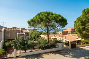 a villa with a tree and a fence at Villa Giovanna - Relax Beach 80m in Solanas