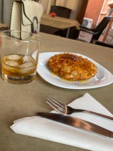 a table with a plate of food and a glass of water at Villa Marogna in Alghero