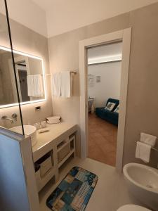 a bathroom with a sink and a mirror at Le Macine Pugnochiuso Holidays in Vieste