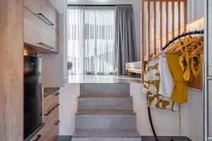 a hallway with a staircase with a yellow towel hanginghiba at Gaia luxury loft in Skiros