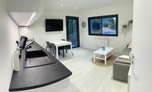 a kitchen with a counter top and a table at Egoitza apartment near Guethary in Saint-Jean-de-Luz