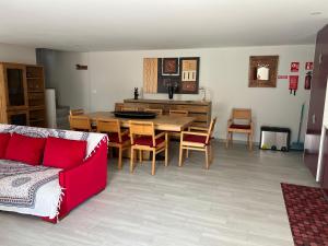 a living room with a couch and a table and chairs at Cantinho Sto Amaro in Arcos de Valdevez