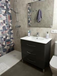 a bathroom with a sink and a shower at La terraza de la subbética in Luque +8 photos