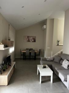a living room with a couch and a table at La terraza de la subbética in Luque