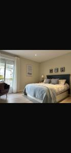 a bedroom with a large bed and a window at La terraza de la subbética in Luque