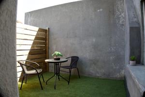 a small table and two chairs on a patio at Le Dreamy - Terrasse et parking in Albertville