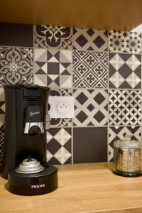 a coffee maker on a counter next to a tile wall at Le Dreamy - Terrasse et parking in Albertville