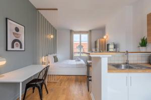 a kitchen and living room with a bed in the background at Grand Place very well located studio in Lille