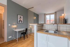 a kitchen with a sink and a desk in it at Grand Place very well located studio in Lille
