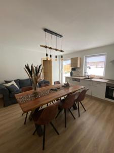 a dining room table and chairs in a living room at Ferienwohnung Fiss Dorfhain 