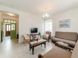 a living room with a couch and a table at Antica holiday house with pool, sea view in Savar