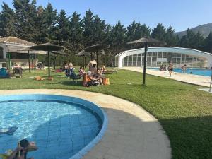a group of people sitting around a swimming pool at House with sauna and fireplace in Ardales