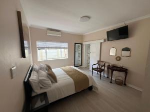 Ένα ή περισσότερα κρεβάτια σε δωμάτιο στο La Vida guest house
