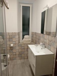 a bathroom with a sink and a mirror and a shower at SOTTO LA ROCCA in Finale Ligure
