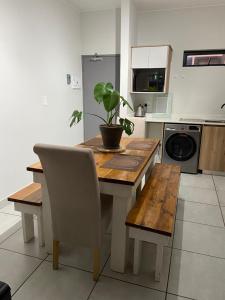 a kitchen with a wooden table with a potted plant on it at Elegant escape in Krugersdorp in Krugersdorp