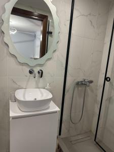 a bathroom with a sink and a mirror at Pefka Apartment in Péfka +16 photos