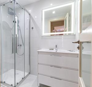 a white bathroom with a shower and a sink at Top Floor Ocean View Apt By Dream Homes Tenerife in Puerto de Santiago +33 photos