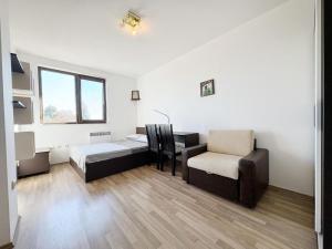 a room with a bed and a chair and a window at Villa Mare Apartment in St. St. Constantine and Helena