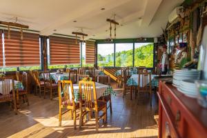 a restaurant with tables and chairs in a room at Etno Gostilnica Villa Fulko in Ohrid