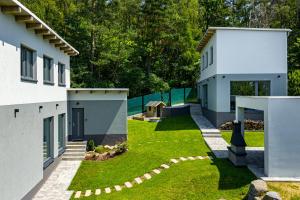 a rendering of a house with a yard at The Houses - Chata u sjezdovky 2 in Velké Meziříčí