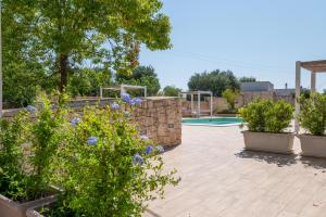 a patio with plants and a swimming pool at Luoghi di Puglia in Ostuni +107 photos