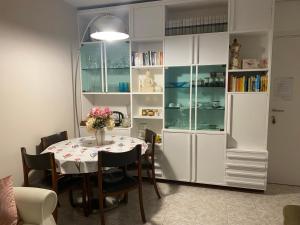 a dining room with a table and book shelves at CASA vicino a Malpensa, VARESE, COMO, MI in Gerenzano