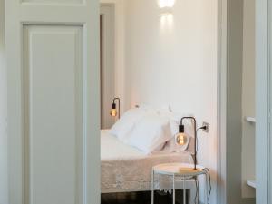 a bedroom with a bed and a table with a lamp at Dimora Storica Palazzo Didonna in Rutigliano +19 photos