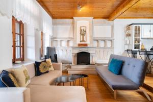 a living room with a couch and a fireplace at Rustic Villa 2 Min walk to the beach heart of Limenaria in Limenaria